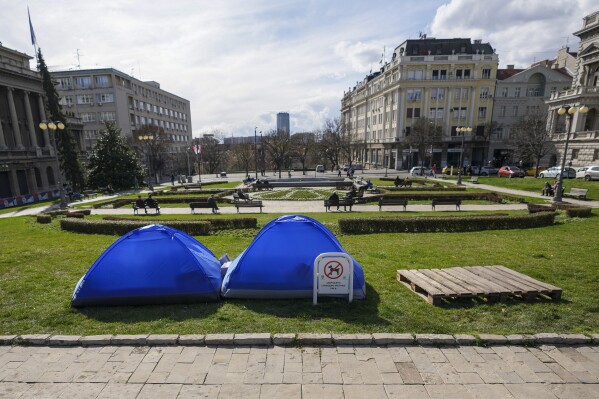 Students and former paramilitary fighters, loyal to President Aleksandar Vucic, are camping outside the presidency building in Belgrade, Serbia, Thursday, March 13, 2025, fueling fears of violent incidents during a major anti-corruption rally this weekend. (AP Photo/Darko Vojinovic)