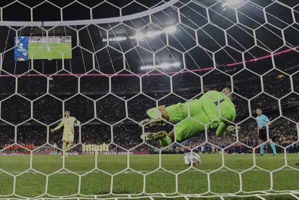 Portugal goalkeeper Diogo Costa makes a save against Spain's Alvaro Morata in the penalty shootout of the Nations League final soccer match between Portugal and Spain at the Allianz Arena in Munich, Germany, Sunday, June 8, 2025. (AP Photo/Martin Meissner)