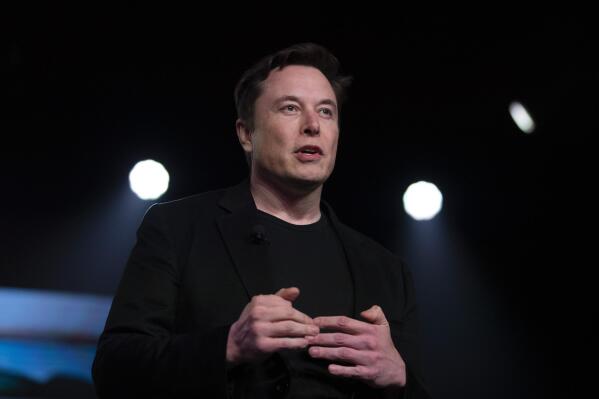 FILE - In this March 14, 2019, file photo, Tesla CEO Elon Musk speaks before unveiling the Model Y at the company's design studio in Hawthorne, Calif. Tesla says it will relocate its headquarters from Palo Alto, Calif., to Austin, Texas, though the electric car maker will keep expanding its manufacturing capacity in the Golden State. Musk gave no timeline for the move late Thursday, Oct. 7, 2021, when he addressed the company's shareholders at Tesla's annual meeting. (AP Photo/Jae C. Hong, File)