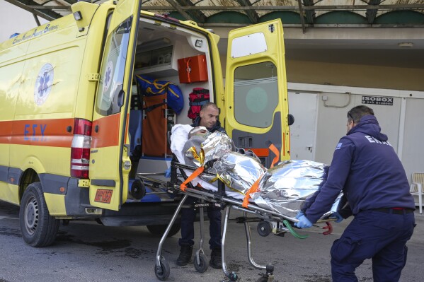 Paramedics transfer a survivor of a shipwreck at a hospital, on the northeastern Aegean Sea island of Lesbos, Greece, Sunday, Nov. 26, 2023. A cargo ship sank off the Greek island of Lesbos early Sunday, leaving 13 crew members missing and one rescued, authorities said. The Raptor, registered in the Comoros, was on its way to Istanbul from Alexandria, Egypt, carrying 6,000 tons of salt, the coast guard said. It had a crew of 14, including eight Egyptians, four Indians and two Syrians, the coast guard said.(AP Photo/Panagiotis Balaskas)