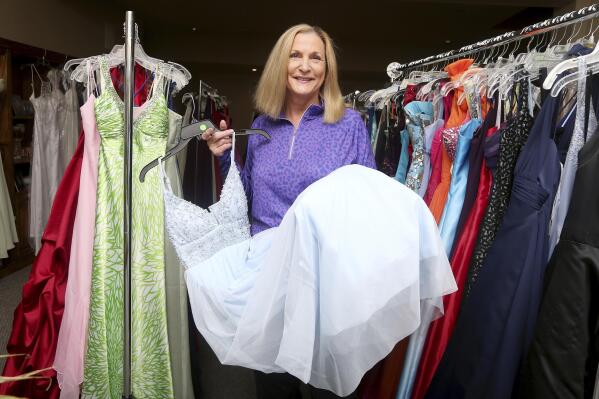 Jean Richardson speaks about the hundreds of prom dresses inside her north Cheyenne, Wyo., home, Tuesday, April 27, 2021. Richardson, the founder of Project Prom Cheyenne, has collected prom dresses for 15 years to give to students. Girls can make appointments to visit her home and find that perfect prom dress, which are mostly donated. (Michael Cummo/The Wyoming Tribune Eagle via AP)