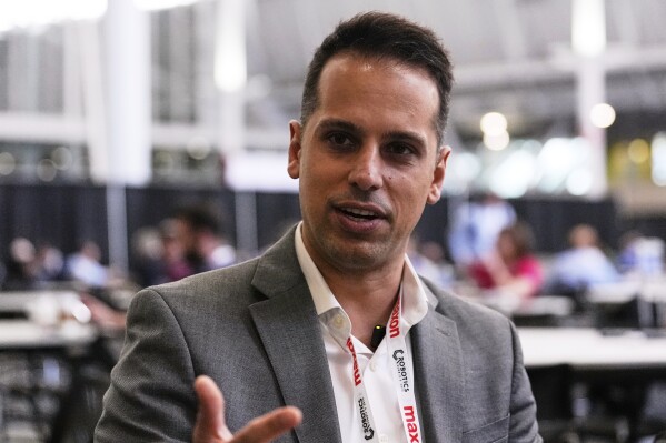 Al Makke, Director of Engineering at Schaeffler Group USA, gestures during an interview at the Robotics Summit & Expo, Wednesday, April 30, 2025, in Boston. (AP Photo/Charles Krupa)