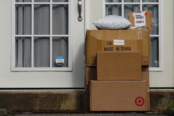 FILE - Packages are seen stacked on the doorstep of a residence, Wednesday, Oct. 27, 2021, in Upper Darby, Pa. Conservatives anxious to counter the U.S.’s leading economic adversary have set their sights on a top trade priority for labor unions and progressives: cracking down on the deluge of duty-free packages coming in from China. The changing political dynamic could have major ramifications for small businesses and consumers importing products from China valued at less than $800. (AP Photo/Matt Slocum)
