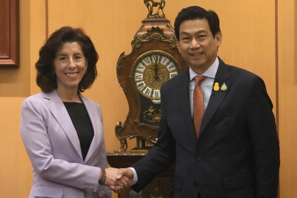 U.S. Secretary of Commerce, Gina Raimondo, left, shakes hand with Thai Foreign Minister Parnpree Bahiddha-Nukara at Foreign Ministry in Bangkok, Thailand, Thursday, March 14, 2024. Raimondo was in Thailand to promote US-Thai trade and investment relations, saying Thailand could benefit from efforts to diversify global supply chains, especially for semiconductors, and that Thailand's plans to emphasize a digital economy will benefit both nations. (AP Photo/Sakchai Lalit)
