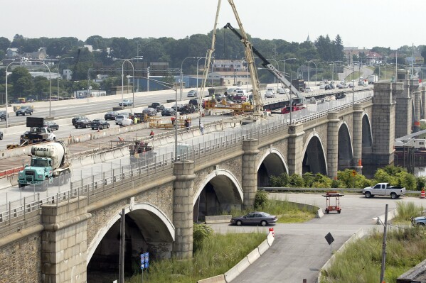 FILE - Construction crews work on the eastbound lanes of the Washington Bridge in Providence, R.I., Aug. 4, 2007. The bridge, that was partially shut down over safety concerns in December, will need to be replaced, Gov. Dan McKee said Thursday, March 14, 2024. (AP Photo/Stew Milne, file)