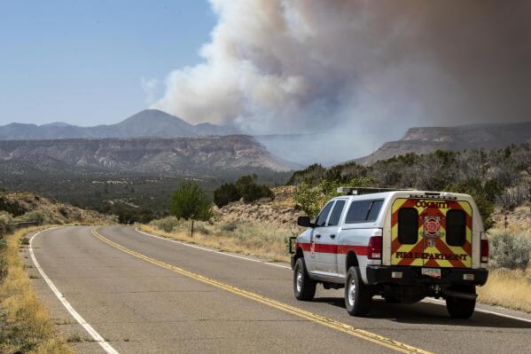 A Cochiti Fire Department vehicle heads towards a plume of smoke from the Cerro Pelado Fire burning in the Jemez Mountains on Friday, April 29, 2022 in Cochiti, N.M.. (Robert Browman//The Albuquerque Journal via AP)
