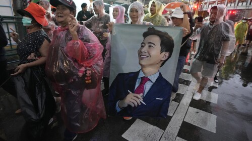 FILE - Supporters of the Move Forward Party hold a portrait of Pita Limjaroenrat, the leader of Move Forward Party, during a protest in Bangkok, Thailand, July 23, 2023. An expected fresh try by Thailand’s Parliament to select a new prime minister on Thursday, July 25, has been postponed, adding to a growing sense of uncertainty over when a new government can take office, more than two months after the country’s general election.(AP Photo/Sakchai Lalit)