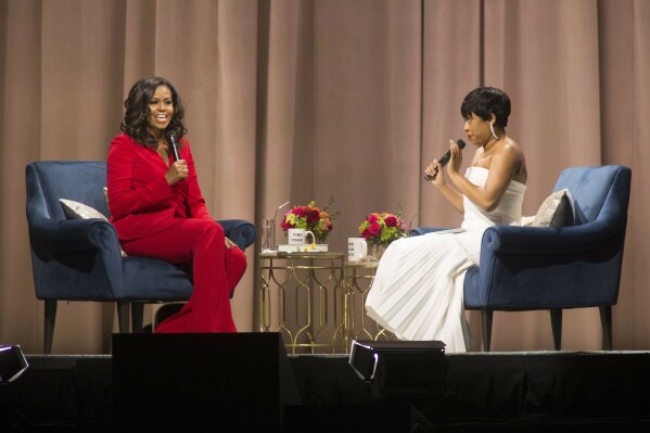 
              Former first lady Michelle Obama, left, is interviewed by Phoebe Robinson during the "Becoming: An Intimate Conversation with Michelle Obama" event at the Wells Fargo Center on Thursday, Nov. 29, 2018, in Philadelphia. (Photo by Owen Sweeney/Invision/AP)
            