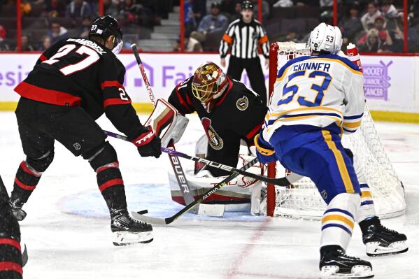 Ottawa Senators goaltender Anton Forsberg (31) watches the puck as center Dylan Gambrell (27) defends against Buffalo Sabres left wing Jeff Skinner (53) during the third period of an NHL hockey game in Ottawa, Ontario, Wednesday, Nov. 16, 2022. (Justin Tang/The Canadian Press via AP)