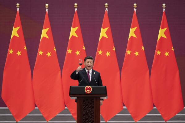 FILE - Chinese President Xi Jinping raises his glass and proposes a toast during the welcome banquet for visiting leaders attending the Belt and Road Forum at the Great Hall of the People, on April 26, 2019. China's Belt and Road Initiative looks to become smaller and greener after a decade of big projects that boosted trade but left big debts and raised environmental concerns. (Nicolas Asfouri/Pool Photo via AP, File)