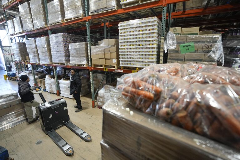 Carlos Quezada, left, and Jerrell Johnson load food onto trucks at Feeding Westchester in Elmsford, N.Y., Wednesday, Nov. 15, 2023. A growing number of states are working to keep food out of landfills over concerns that it is taking up too much space and posing environmental problems. Some states including New York are requiring supermarkets and other businesses to redirect food to food pantries. (AP Photo/Seth Wenig)