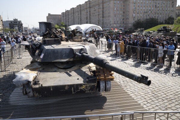 Representatives of the diplomatic corps look at U.S.-made M1 Abrams tank, and other U.S. military vehicles, hit and captured by Russian troops during the fighting in Ukraine as they visit an exhibition of Western military equipment seized from Ukrainian forces, in Moscow, on Friday, May 31, 2024. The exhibit, organized by the Russian Defense Ministry, features more than 30 pieces of Western-made heavy equipment, including a U.S.-made M1 Abrams tank and a Bradley armored fighting vehicle. (AP Photo/Alexander Zemlianichenko)