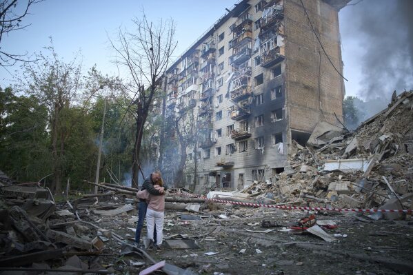 Residents react after a Russian missile hit a multi-storey apartment during Russia's combined missile and drone air attack in Kyiv, Ukraine, Tuesday, June 17, 2025. (AP Photo/Efrem Lukatsky)