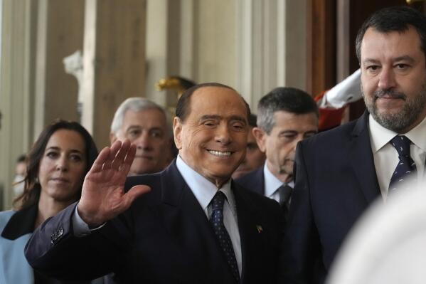 FILE - Forza Italia's president Silvio Berlusconi waves, center, flanked by The League leader Matteo Salvini, right, and Senator Licia Ronzulli, left, as they arrive at the Quirinale Presidential Palace after a meeting with Italian President Sergio Mattarella as part of a round of consultations with party leaders to try and form a new government, in Rome, on Oct. 21, 2022. Former Premier Berlusconi has once again put himself at odds with Premier Giorgia Meloni, whose coalition government his party supports, by openly criticizing her for meeting with Ukraine’s leader, whom he blames for the year-old Russian invasion. (AP Photo/Gregorio Borgia, File)