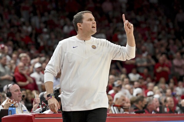 FILE - Then-LSU coach Will Wade gestures during the first half of an NCAA college basketball game against Arkansas, Wednesday, March 2, 2022, in Fayetteville, Ark. An independent infractions panel handed a two-year show-cause penalty and a 10-game suspension to former LSU and current McNeese State men's basketball coach Will Wade on Thursday, June 22, 2023, for multiple rules violations. (AP Photo/Michael Woods, File)