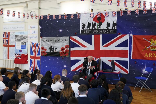 D-Day veteran and Ambassador for the British Normandy Memorial, Ken Hay, 98, who served with the 4th Dorset Regiment, speaks to children during a visit to Rush Green Primary School in Dagenham, England, Monday May 20, 2024, ahead of the 80th anniversary of the D-Day landings. (Gareth Fuller/PA via AP)