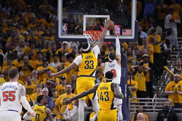 Indiana Pacers center Myles Turner (33) blocks a shot by New York Knicks guard Josh Hart (3) during the second half of Game 3 in an NBA basketball second-round playoff series, Friday, May 10, 2024, in Indianapolis. (AP Photo/Michael Conroy)