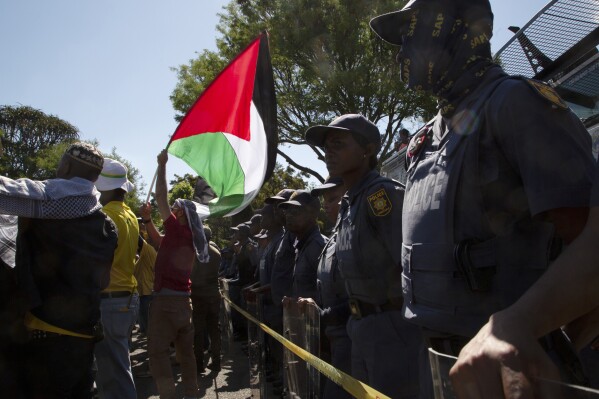 FILE - Pro-Palestinian supporters demonstrate at the entrance to the Israeli embassy in Pretoria, South Africa, Friday, Oct. 20, 2023. Israel has recalled its ambassador to South Africa, Eliav Belotserkovsky, back to Jerusalem 