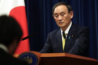 FILE - In this Dec. 4, 2020, file photo, Japanese Prime Minister Yoshihide Suga speaks during a news conference in Tokyo. Suga on Sunday, April 4, 2021, said Taiwan's peace and stability is key to the region and that Japan will cooperate with the United States to calm rising tensions between China and Taiwan.(AP Photo/Hiro Komae, File)