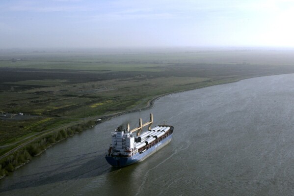 FILE - A ship sails through the Sacramento-San Joaquin River Delta near Bethel Island, Calif., on March 12, 2008. Sacramento Superior Court Judge Kenneth C. Mennemeier ruled Thursday, Jan. 18, 2024, that the state does not have permission to borrow billions of dollars for a water project. The decision could threaten a key source of funding for a plan to build a tunnel to reroute the state's water supply from the Central Valley to the densely populated southern portion of the state. (AP Photo/Rich Pedroncelli, File)