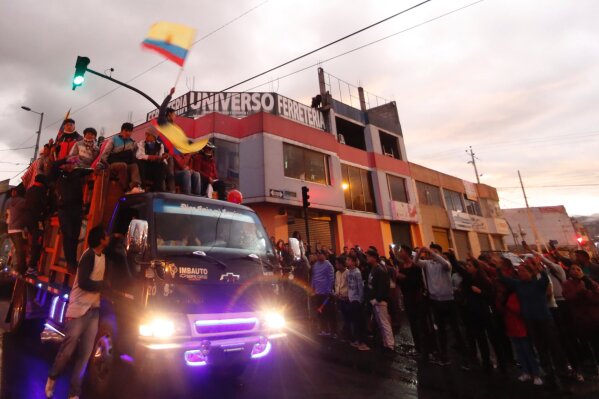 Indigenous protesters arrive on a truck from their communities to join anti-government protests in Quito, Ecuador, Monday, Oct. 7, 2019. Ecuador has endured days of popular upheaval since President Lenín Moreno scrapped fuel price subsidies, a step that set off protests and clashes across the small South American country. (AP Photo/Dolores Ochoa)