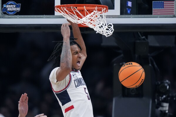 UConn guard Stephon Castle (5) roars while dunking against San Diego State during the second half of the Sweet 16 college basketball game in the men's NCAA Tournament, Thursday, March 28, 2024, in Boston. (AP Photo/Steven Senne)