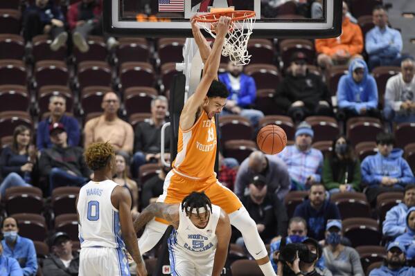 Tennessee's Olivier Nkamhoua (13) dunks over North Carolina's Armando Bacot (5) in the second half of an NCAA college basketball game, Sunday, Nov. 21, 2021, in Uncasville, Conn. (AP Photo/Jessica Hill)