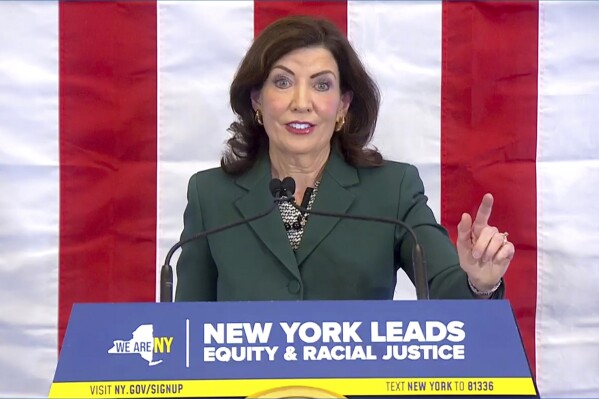 CORRECTS CITY TO NEW YORK - This image from video provided by the Office of The Governor, shows New York Gov. Kathy Hochul as she delivers remarks before signing a bill in New York, Tuesday, Dec. 19, 2023, to create a commission tasked with considering reparations to address the persistent, harmful effects of slavery in the state. (Office of the Governor via AP)