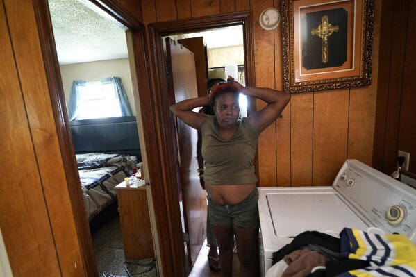 Patricia Bingo Lavergne reacts as she sees the inside of her damaged home for the first time in Lake Charles, La., after returning home after evacuating from Hurricane Laura, Sunday, Aug. 30, 2020. (AP Photo/Gerald Herbert)
