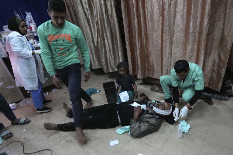FILE - Palestinians wounded in the Israeli bombardment of the Gaza Strip are brought to Al-Aqsa Martyrs Hospital in Deir al Balah, Gaza Strip, Friday, March 8, 2024. (AP Photo/Adel Hana, File)