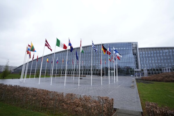Flags of NATO member countries flap in the wind outside NATO headquarters in Brussels, Wednesday, April 3, 2024. NATO foreign ministers gathered in Brussels on Wednesday to debate plans to provide more predictable, longer-term support to Ukraine. (AP Photo/Virginia Mayo)