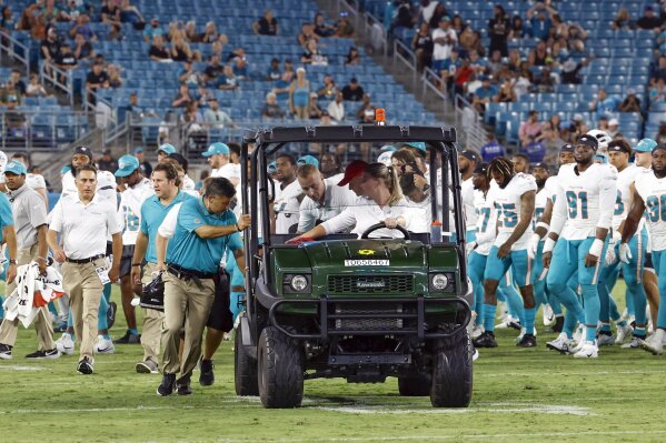 Miami Dolphins wide receiver Daewood Davis (87) is carted off the field during the team's NFL preseason football game against the Jacksonville Jaguars, Saturday, Aug. 26, 2023, in Jacksonville, Fla. (Al Diaz/Miami Herald via AP)