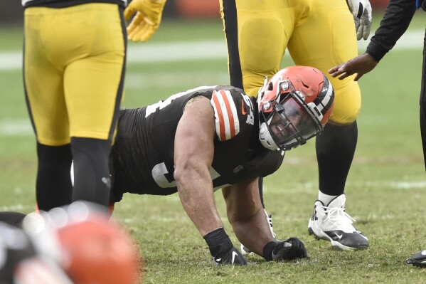 Cleveland Browns defensive end Olivier Vernon reacts after an injury in the fourth quarter of an NFL football game against the Pittsburgh Steelers, Sunday, Jan. 3, 2021, in Cleveland. Hamstring pulls, ligament tears and ankle sprains can be as formidable an opponent for NFL teams as a high-scoring offense or stingy defense. (AP Photo/David Richard)