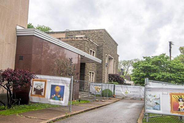A windscreen installation titled #HeartsTogether: The Art of Rebuilding decorate the perimeter fence of the Tree of Life synagogue, which housed three congregations, New Light, Dor Hadash and Tree of Life, Monday, May 3, 2021, in the Squirrel Hill neighborhood of Pittsburgh. Tree of Life officials last week announced Daniel Libeskind as lead architect for the reconstruction of their synagogue, where in October 2018 a gunman killed 11 worshipers. (Alexandra Wimley/Pittsburgh Post-Gazette via AP)
