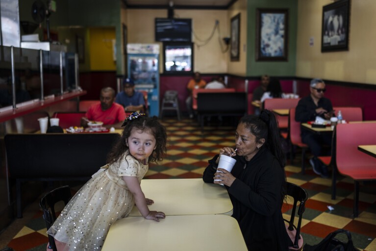Deneffy Sánchez's mother, Lilian Lopez, keeps her young daughter out of the house most of the day to avoid bothering their roommate, in Los Angeles, Sunday, June 25, 2023. Pandemic job loss coupled with rising rents have pushed many California residents into desperate housing arrangements. (AP Photo/Jae C. Hong)