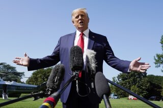 President Donald Trump speaks with reporters as he walks to Marine One on the South Lawn of the White House, Monday, Aug. 17, 2020, in Washington. Trump is en route to Minnesota and Wisconsin. (AP Photo/Alex Brandon)
