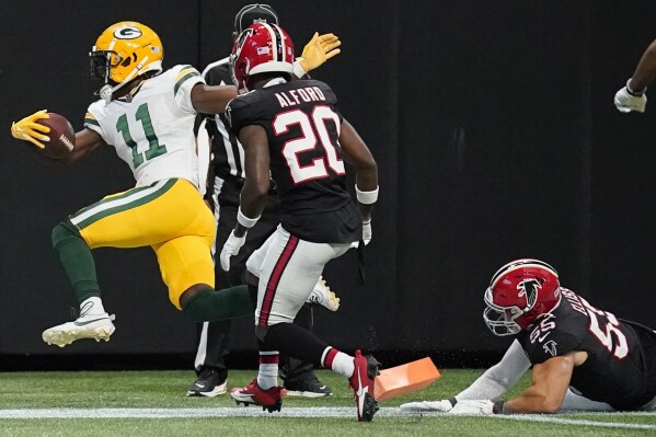 Green Bay Packers wide receiver Jayden Reed (11) scores a touchdown in the end zone against Atlanta Falcons cornerback Dee Alford (20) during the first half of an NFL football game, Sunday, Sept. 17, 2023, in Atlanta. (AP Photo/Brynn Anderson)
