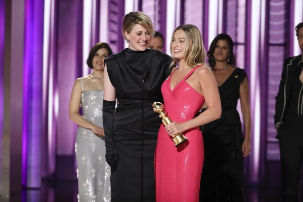 This image released by CBS shows co-director Greta Gerwig, left, and actor Margot Robbie accepting the award for best cinematic and box office achievement for the film "Barbie" during the 81st Annual Golden Globe Awards in Beverly Hills, Calif., on Sunday, Jan. 7, 2024. (Sonja Flemming/CBS via AP)