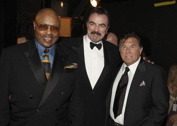 FILE - The cast of "Magnum PI," from left, Roger E. Mosley, Tom Selleck, and Larry Manetti appear backstage at the TV Land Awards on April 19, 2009 in Universal City, California.  (AP Photo/Matt Sills, file)