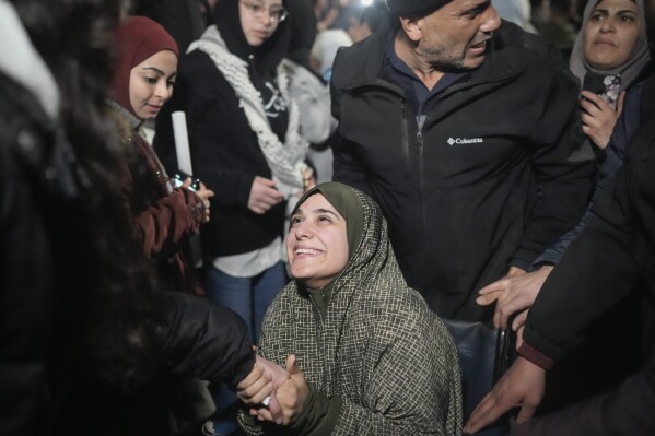 A female Palestinian prisoner in a wheelchair is greeted following her release from an Israeli prison, in the West Bank city of Beitunia, early Monday, Jan. 20, 2025. (AP Photo/Leo Correa, File)