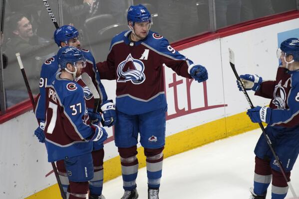 Colorado Avalanche right wing Mikko Rantanen, second from right, celebrates his goal against the San Jose Sharks with J.T. Compher, center Nazem Kadri and defenseman Cale Makar, from left, during the third period of an NHL hockey game Thursday, March 31, 2022, in Denver. (AP Photo/David Zalubowski)