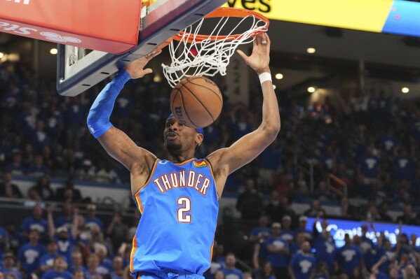 Oklahoma City Thunder's Shai Gilgeous-Alexander (2) dunks in the second half of Game 7 in the Western Conference semifinals of the NBA basketball playoffs against the Denver Nuggets, Sunday, May 18, 2025, in Oklahoma City. (AP Photo/Kyle Phillips)