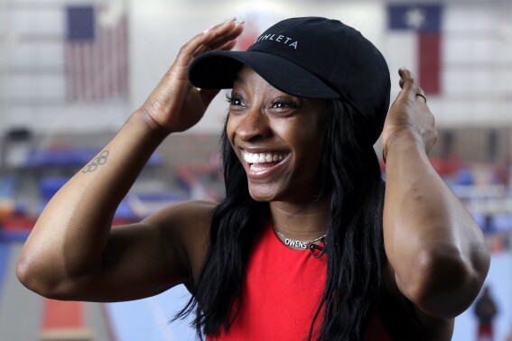 Olympic gold medalist Simone Biles Owens is interviewed after training at the Stars Gymnastics Sports Center in Katy, Texas, Monday, Feb. 5, 2024. Biles begins preparations for the Paris Olympics when she returns to competition at the U.S. Classic in Hartford, Connecticut on Saturday. Biles, who cited mental health concerns while removing herself from several competitions at the Tokyo Olympics, says she is better prepared for the pressure competing presents this time around. (AP Photo/Michael Wyke)