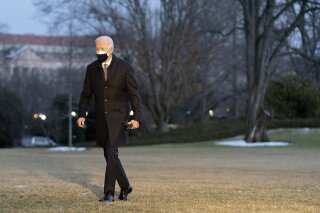 President Joe Biden walks on the South Lawn of the White House after stepping off Marine One, Friday, Feb. 19, 2021, in Washington. Biden is returning to Washington after visiting Pfizer's COVID-19 vaccine manufacturing site near Kalamazoo, Mich. (AP Photo/Patrick Semansky)