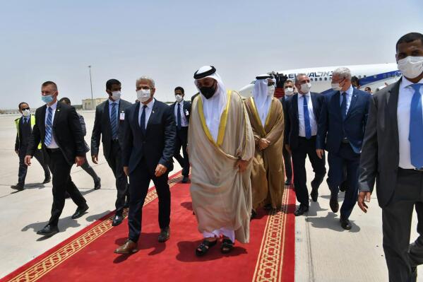 In this photo made available by the Israeli Government Press Office, Israeli Foreign Minister Yair Lapid, center left, arrives in Abu Dhabi, United Arab Emirates, Tuesday, June 29, 2021. Israel’s new foreign minister is in the UAE on the first high-level trip by an Israeli official to the Gulf Arab state since the two countries normalized relations last year. (Shlomi Amsalem/Government Press Office via AP)