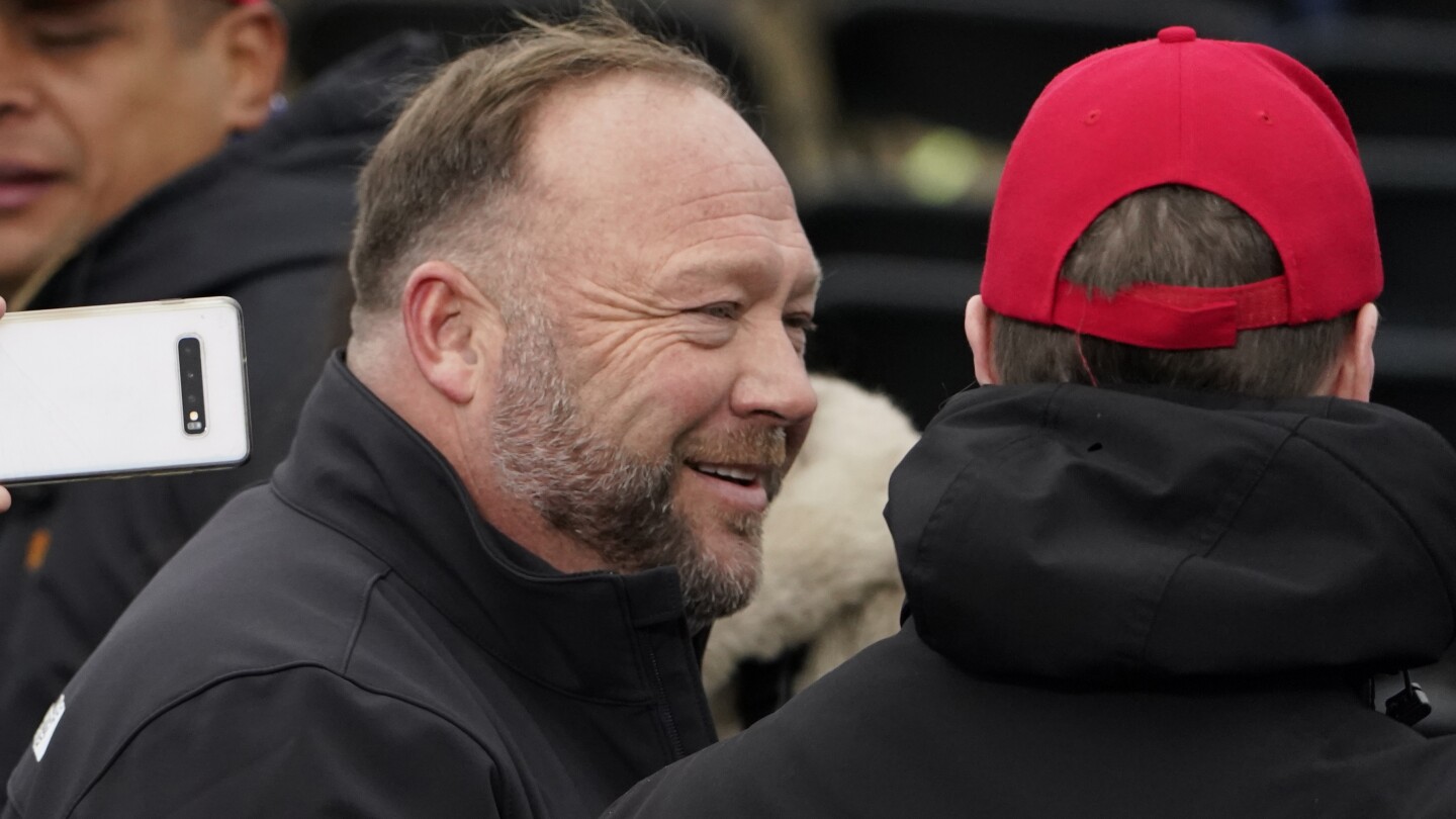 FILE - Alex Jones, left, attends a rally in support of President Donald Trump called the “Save America Rally,” on Jan. 6, 2021, in Washington. Elo