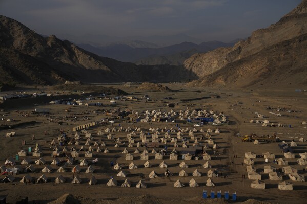 Tents stand in a migrant camp at the Pakistan-Afghanistan border in Torkham, Afghanistan, Friday, Nov. 17, 2023. Pakistan’s decision to deport Afghans who entered illegally struck hard. Many Afghans have lived for decades in Pakistan, driven there by successive wars at home. (AP Photo/Ebrahim Noroozi)
