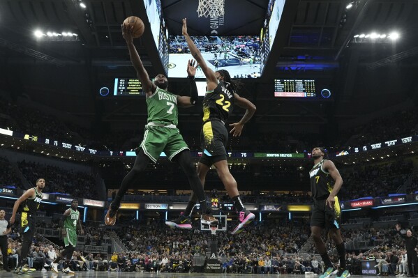 Boston Celtics guard Jaylen Brown (7) shoots around Indiana Pacers forward Isaiah Jackson (22) during the second half of an NBA basketball game in Indianapolis, Saturday, Jan. 6, 2024. (AP Photo/AJ Mast)