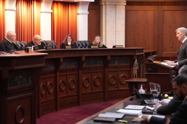 Attorney Eric Olson, far right, argues before the Colorado Supreme Court on Wednesday, Dec. 6, 2023, in Denver. Colorado Supreme Court justices have sharply questioned whether they could exclude former President Donald Trump from the state's 2024 ballot. (AP Photo/David Zalubowski, Pool)