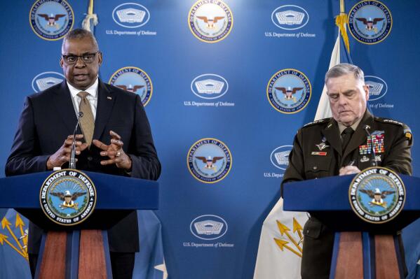 Secretary of Defense Lloyd Austin, left, accompanied by Chairman of the Joint Chiefs, Gen. Mark Milley, speaks during a briefing at the Pentagon in Washington, Wednesday, March 15, 2023. (AP Photo/Andrew Harnik)